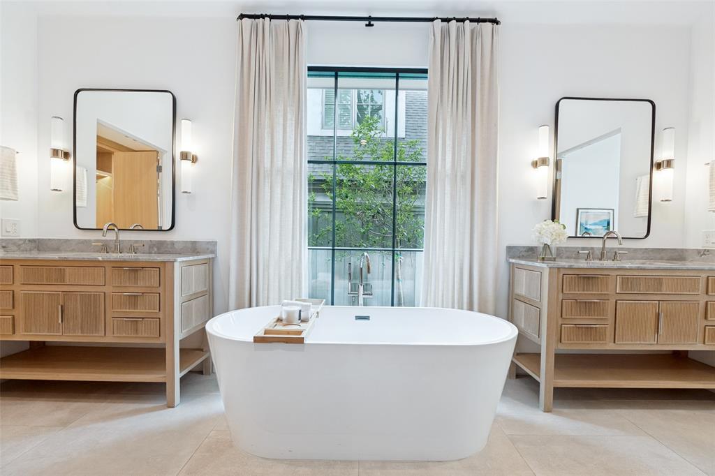 4325 Pomona Road Dallas, TX 75209 - Photo 18 of 23 Freestanding soaking tub centered under a large window with black framing