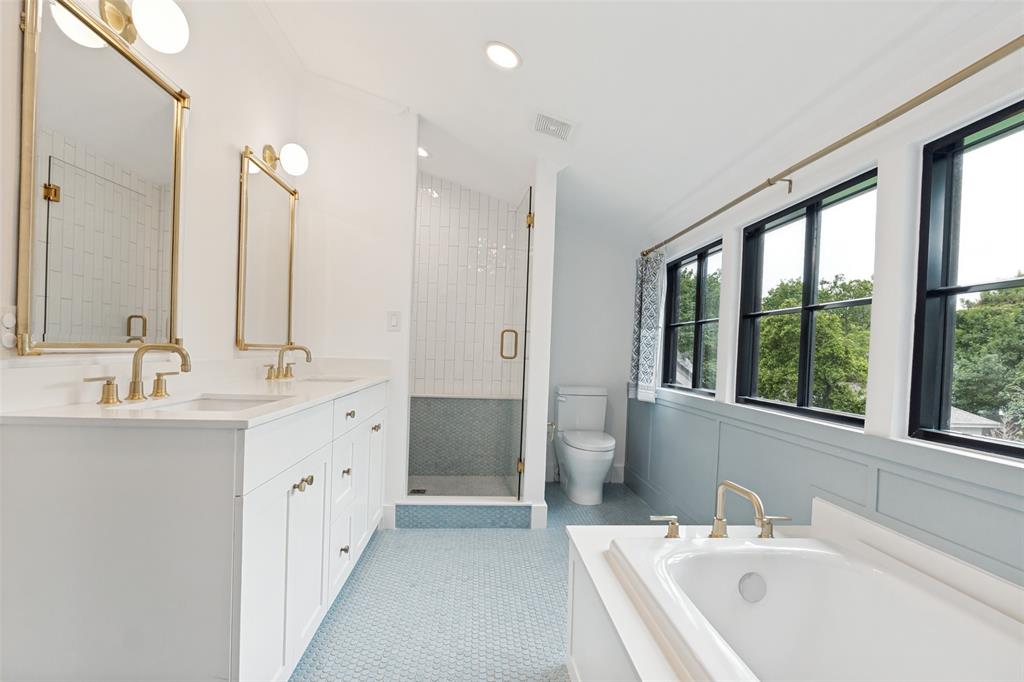 4325 Pomona Road Dallas, TX 75209 - Photo 19 of 23 Bathroom featuring a dual vanity with white cabinetry, gold-finish hardware, and marble countertops