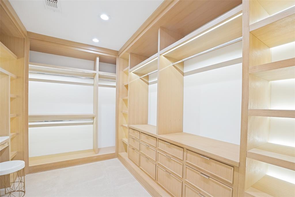 4325 Pomona Road Dallas, TX 75209 - Photo 20 of 23 Custom closet featuring light wood-finish cabinetry, integrated shelving, multiple hanging rods, and built-in drawers