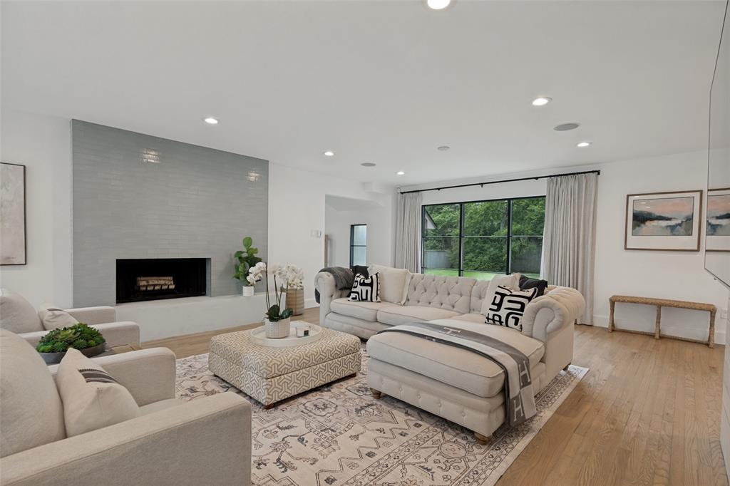 4325 Pomona Road Dallas, TX 75209 - Photo 6 of 23 Spacious living area featuring a linear fireplace with a textured tile surround and hearth