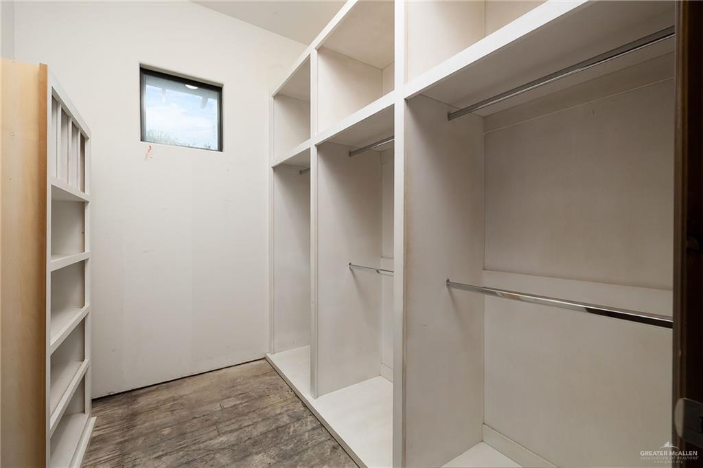 22111 Uresti Road Edinburg, TX 78542 - Photo 24 of 38 Built-in shelving, multiple hanging rods, and a window