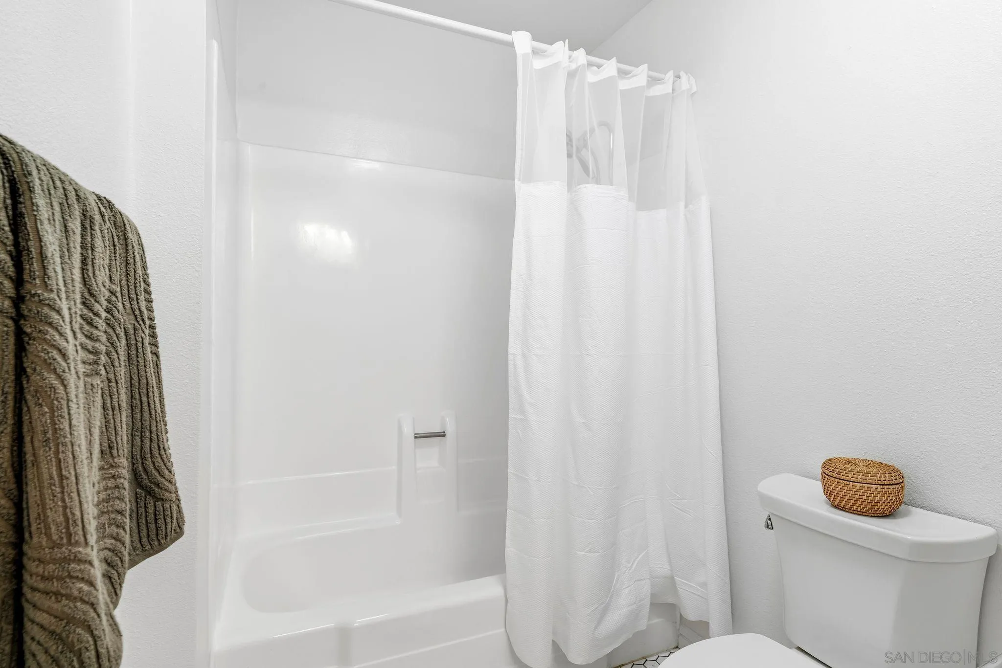 10226 Black Mountain Road, Unit 83 San Diego, CA 92126 - Photo 15 of 23 a bathroom with a shower curtain and a toilet