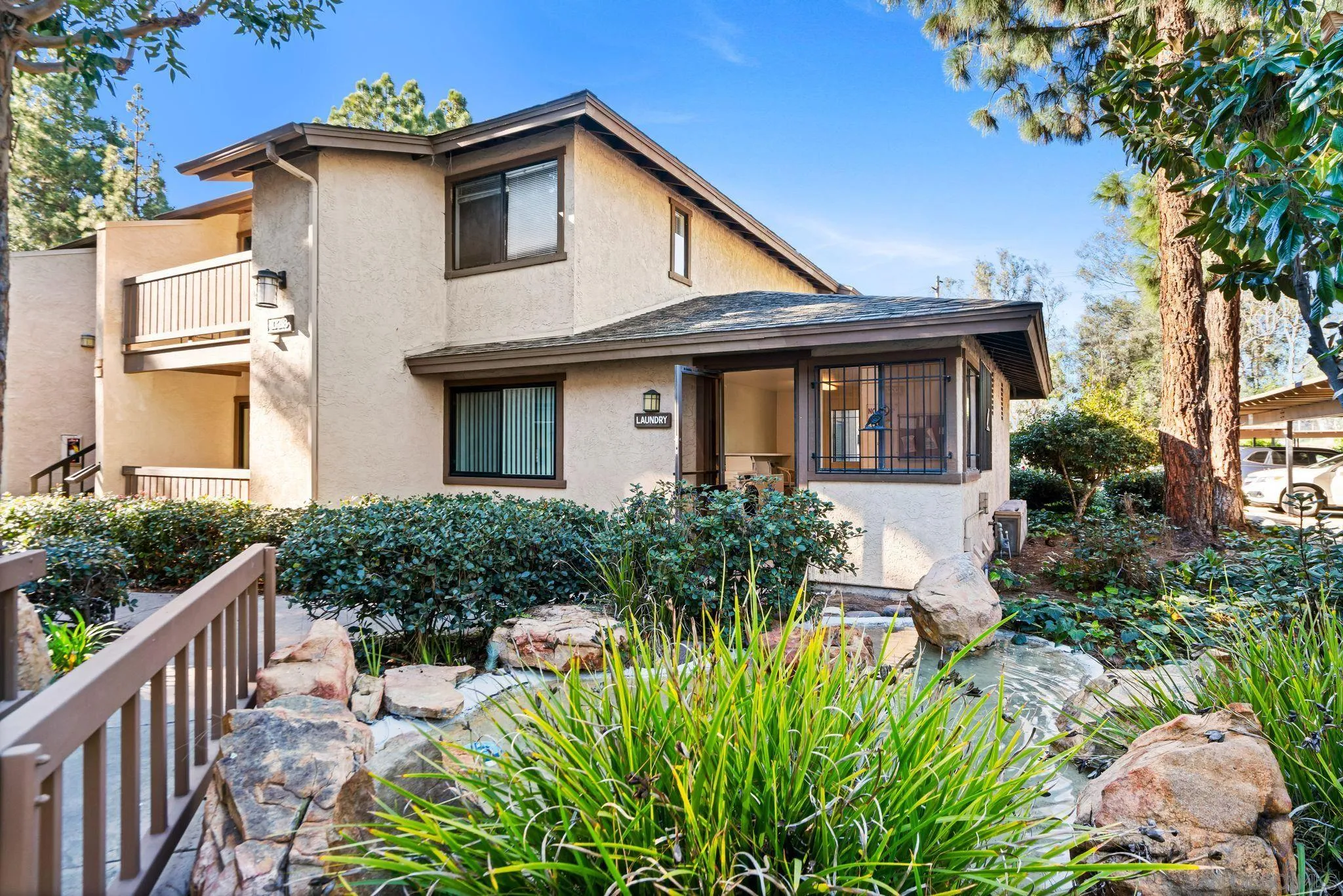 10226 Black Mountain Road, Unit 83 San Diego, CA 92126 - Photo 20 of 23 a front view of house with yard and green space