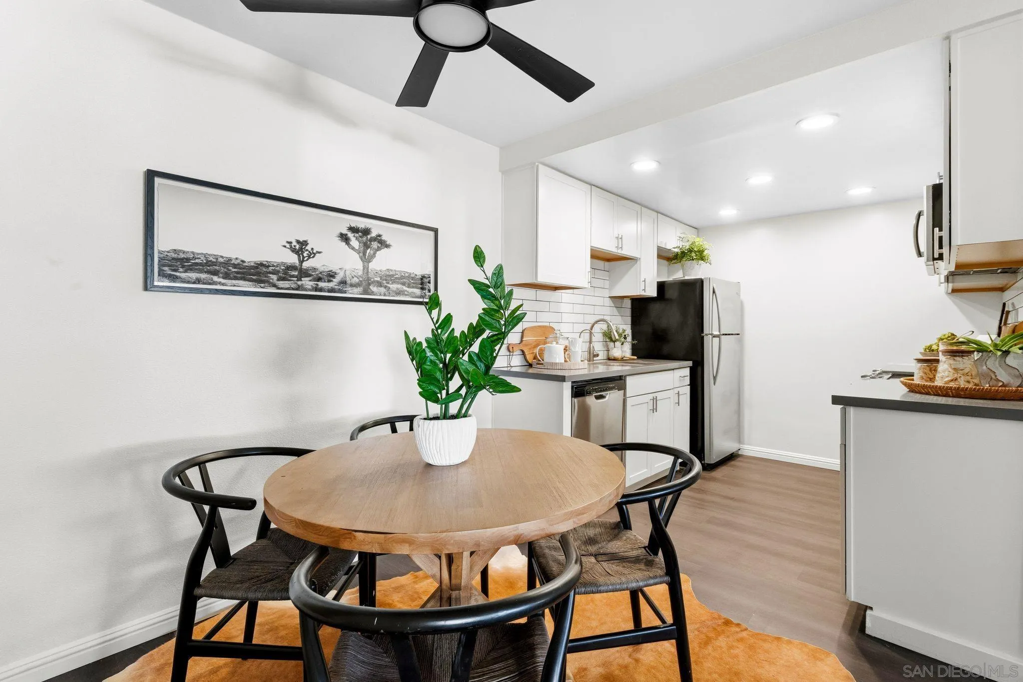 10226 Black Mountain Road, Unit 83 San Diego, CA 92126 - Photo 4 of 23 a view of a dining room with furniture and wooden floor