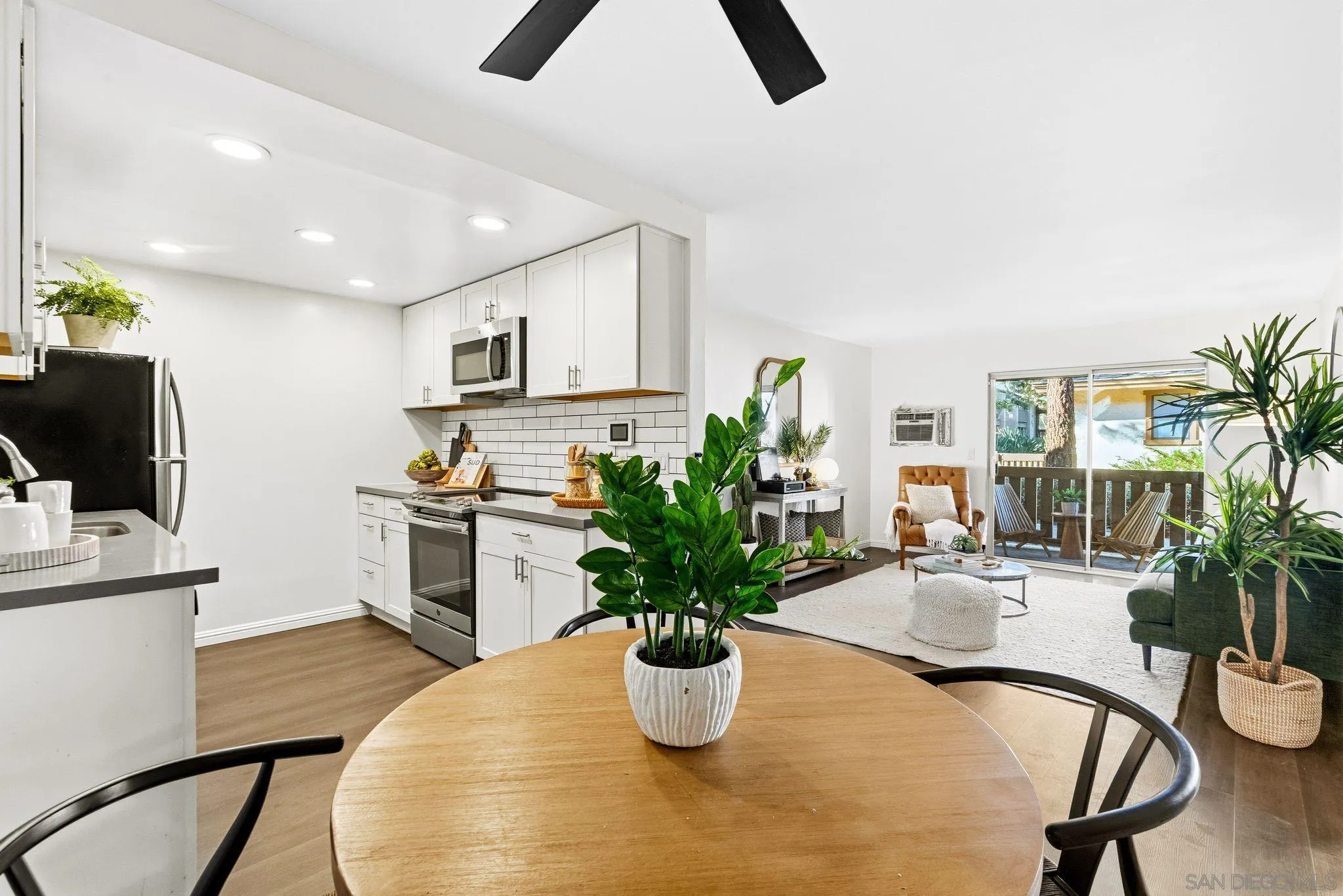 10226 Black Mountain Road, Unit 83 San Diego, CA 92126 - Photo 5 of 23 a kitchen with a refrigerator and a potted plant