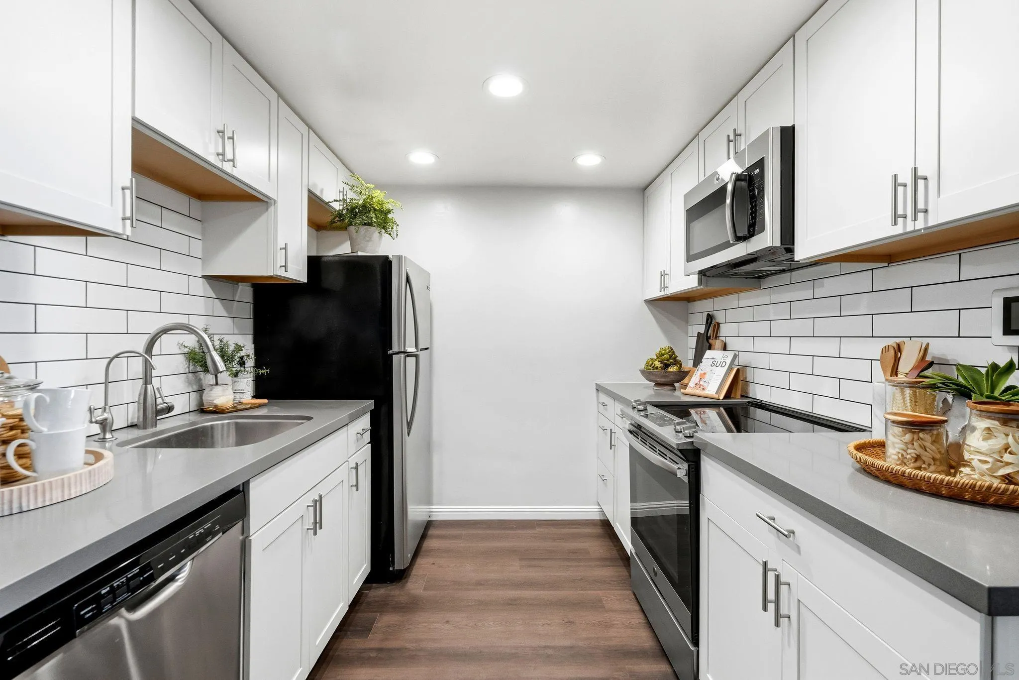 10226 Black Mountain Road, Unit 83 San Diego, CA 92126 - Photo 6 of 23 a kitchen with stainless steel appliances granite countertop a sink stove and refrigerator