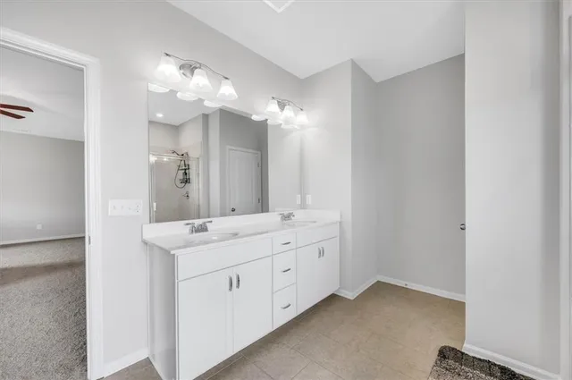 a bathroom with a sink vanity and a mirror