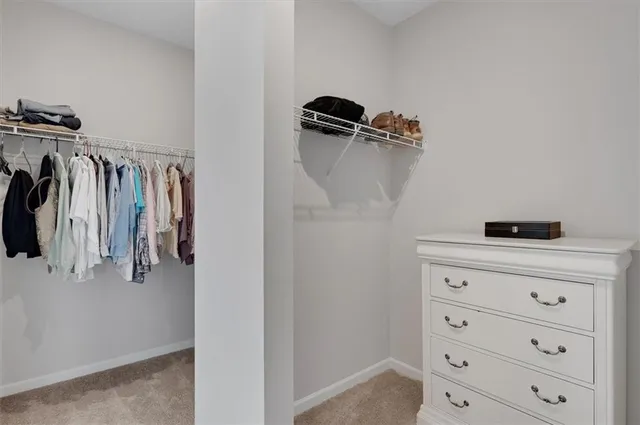 a view of walk in closet with clothes