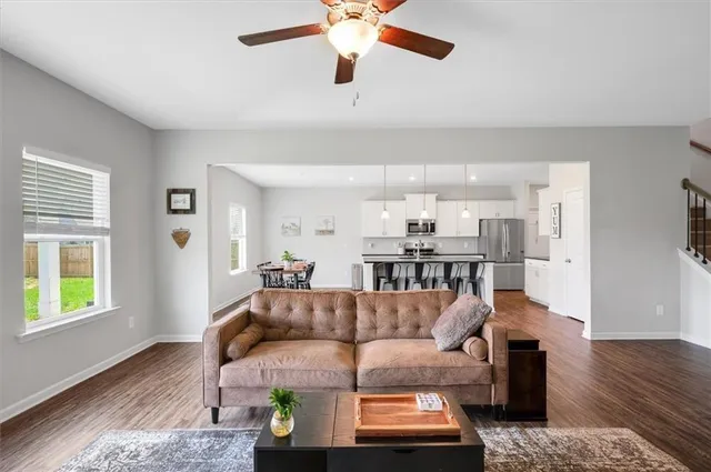 a living room with furniture and a wooden floor