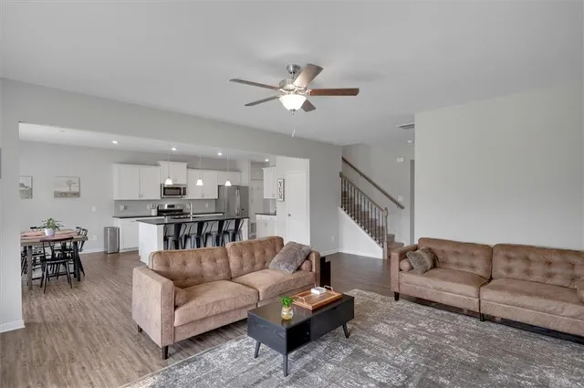 a living room with furniture and kitchen view