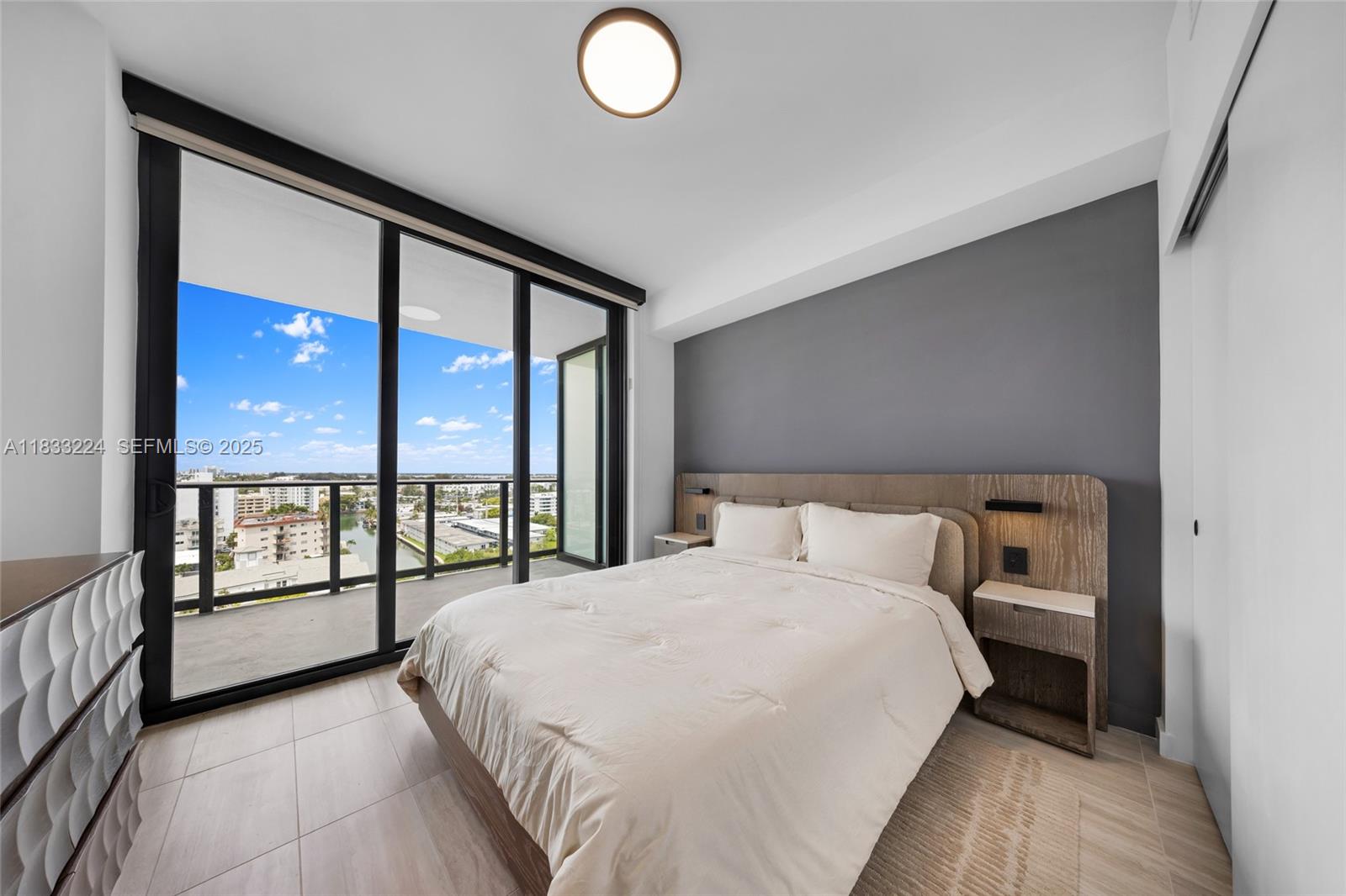 580 72nd Street, Unit 910 Miami Beach, FL 33141 - Photo 57 of 60 a bedroom with a large bed and a large window