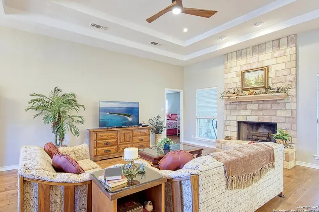 a living room with furniture a wooden floor and a large window