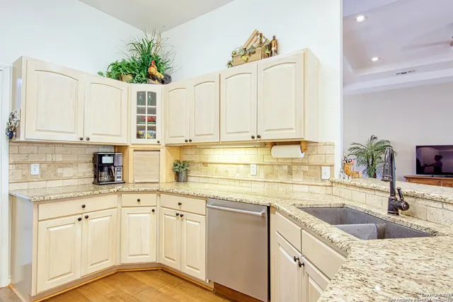 a kitchen with stainless steel appliances a refrigerator sink and cabinets
