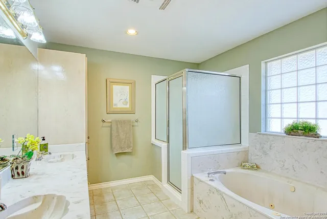 a en suite bathroom with a granite countertop sink and a mirror