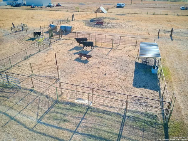 an aerial view of ocean and residential houses with outdoor space
