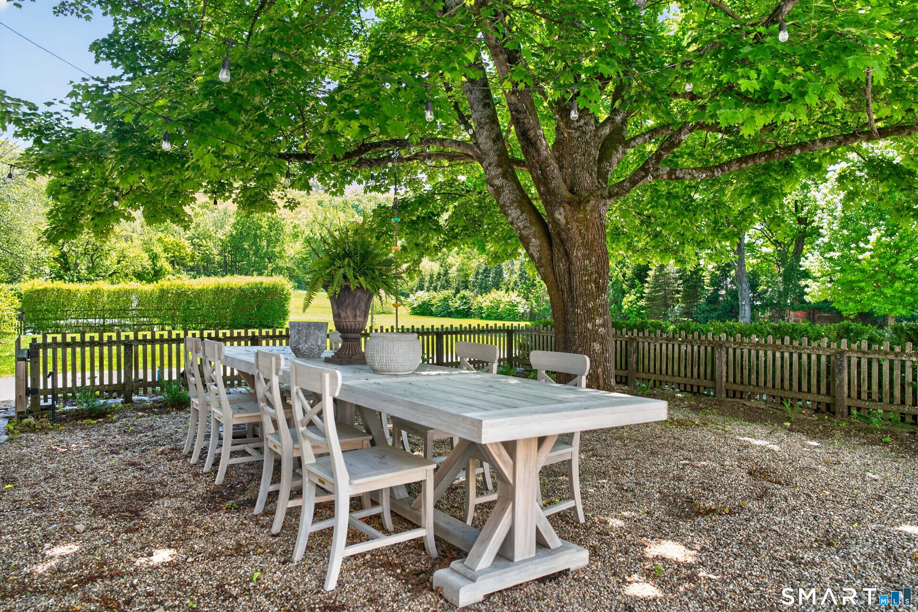 100 North Main Street Kent, CT 06757 - Photo 6 of 40 a view of a patio with table and chairs with wooden fence and plants