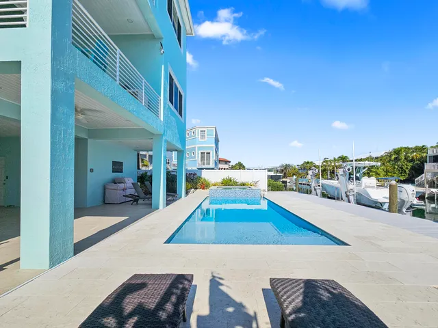 a view of a balcony with two chairs and a table