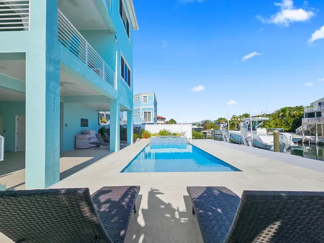 a view of a dining room with furniture a chandelier and wooden floor