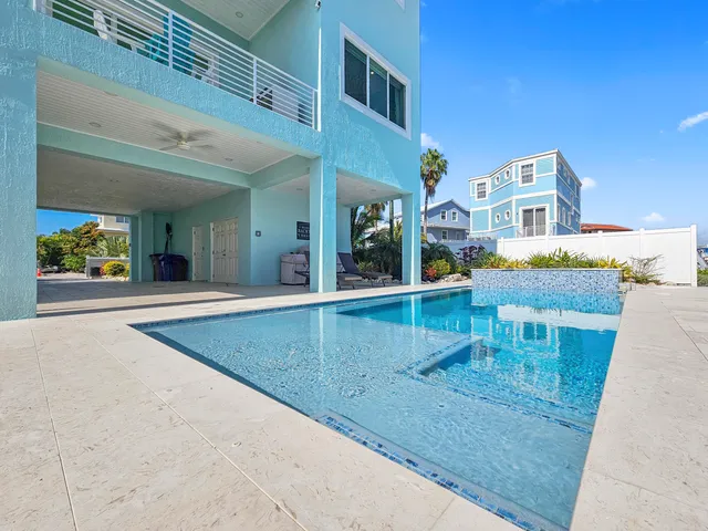 a view of a dining room with furniture a chandelier and wooden floor