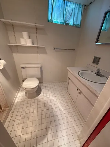 a bathroom with a sink toilet and vanity