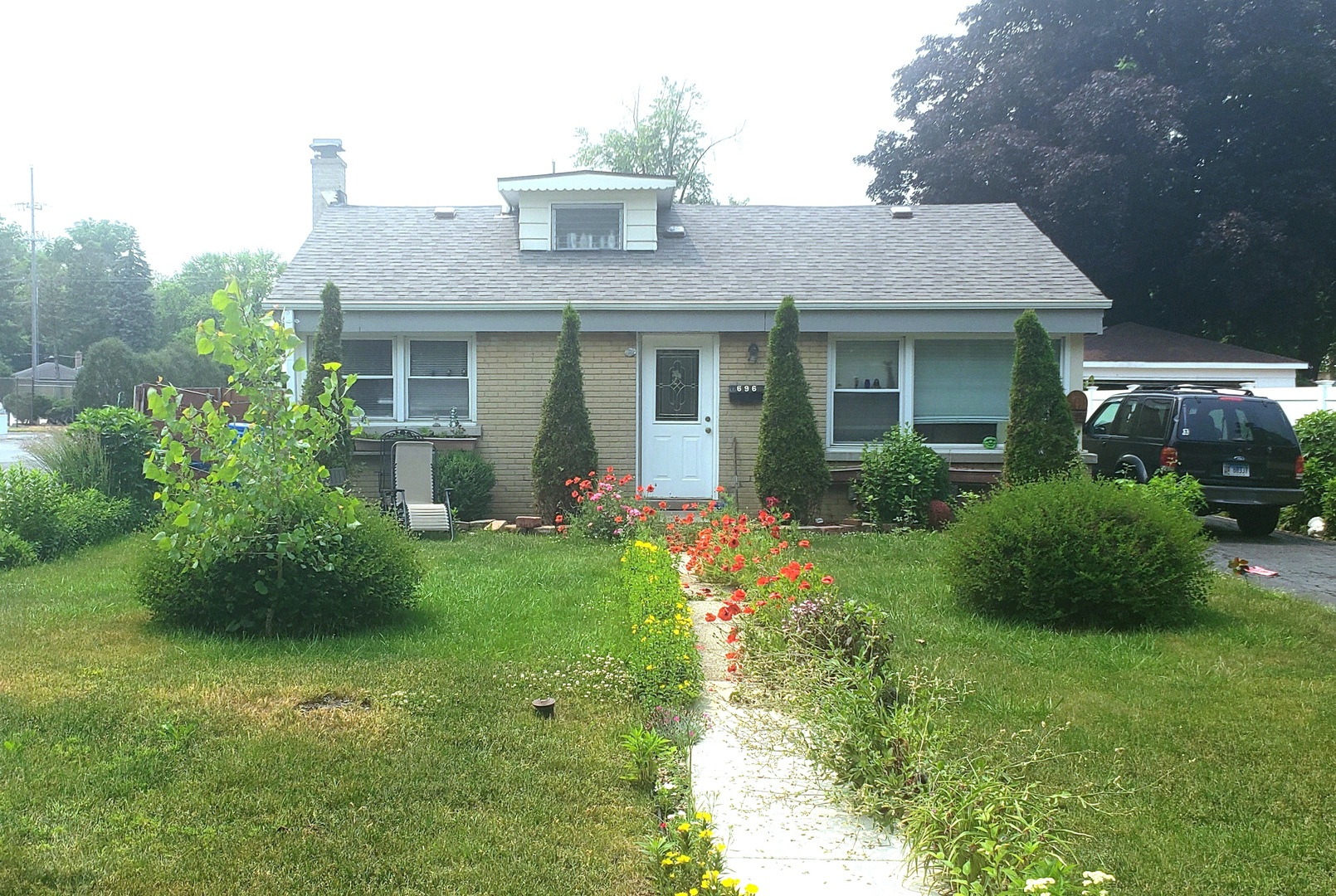 a front view of a house with garden