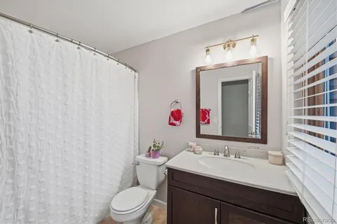 a bathroom with a sink vanity mirror and toilet