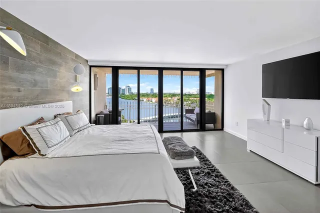 a bedroom with a large bed and a large window