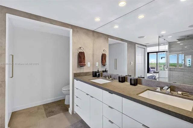 a bedroom with a large bed and a large window