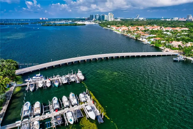 an aerial view of a house with outdoor swimming pool and tennis court
