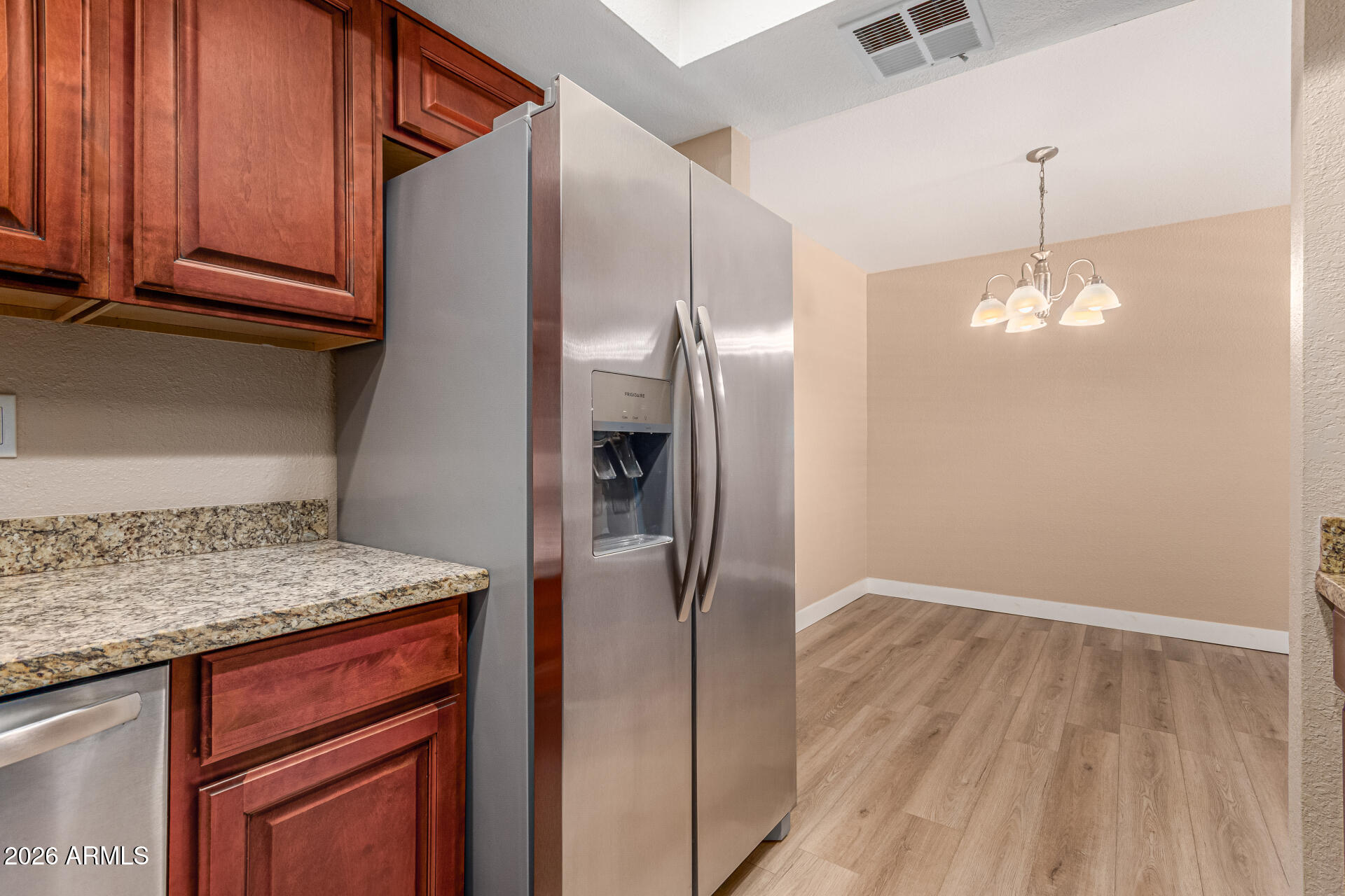 1340 North Recker Road, Unit 343 Mesa, AZ 85205 - Photo 12 of 28 a kitchen with stainless steel appliances granite countertop a refrigerator and a sink