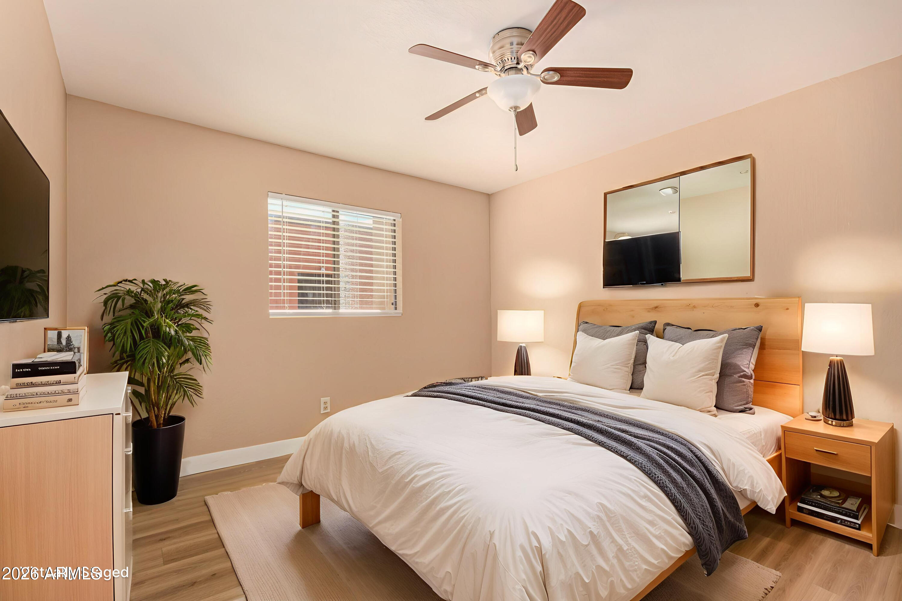 1340 North Recker Road, Unit 343 Mesa, AZ 85205 - Photo 13 of 28 a bedroom with a bed and a potted plant