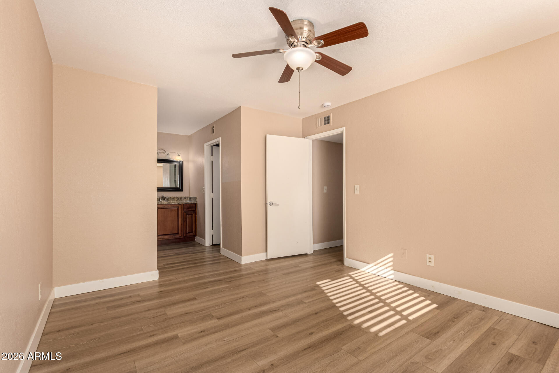 1340 North Recker Road, Unit 343 Mesa, AZ 85205 - Photo 15 of 28 a view of an empty room and wooden floor