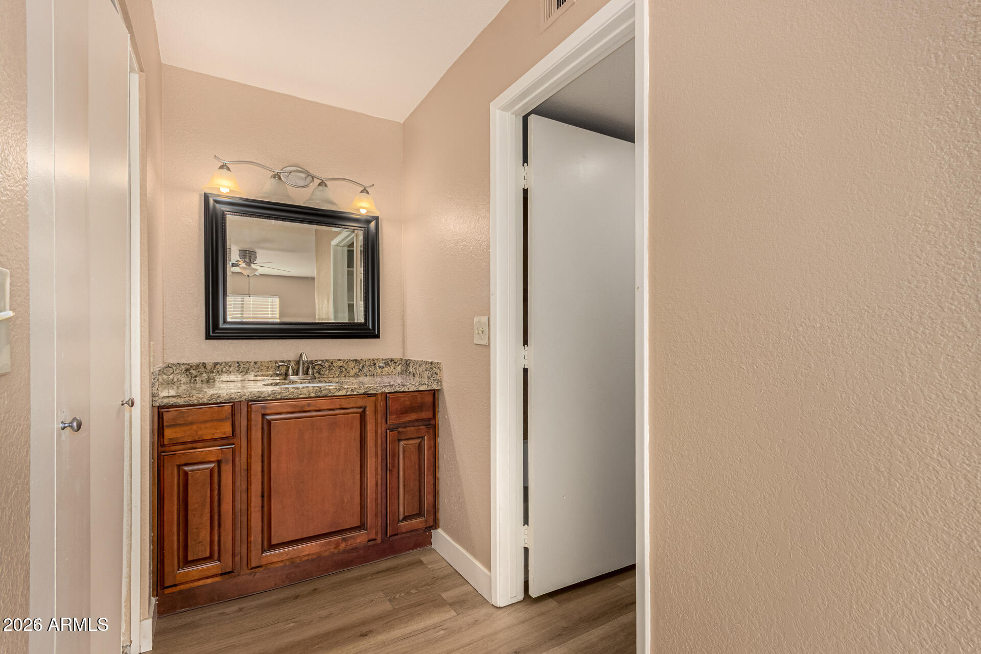 1340 North Recker Road, Unit 343 Mesa, AZ 85205 - Photo 16 of 28 a bathroom with a toilet sink and mirror