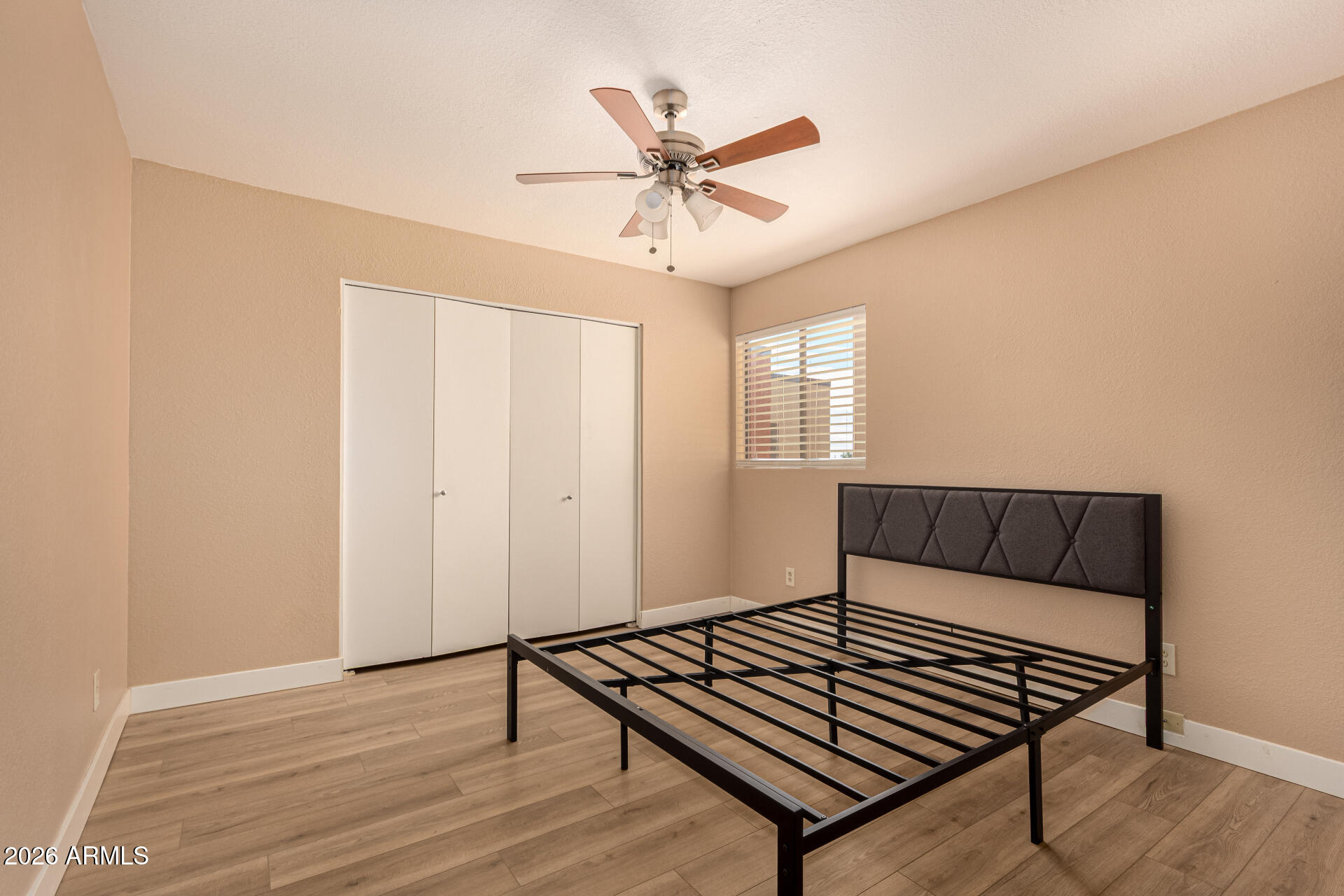 1340 North Recker Road, Unit 343 Mesa, AZ 85205 - Photo 20 of 28 a view of an empty room with window and wooden floor