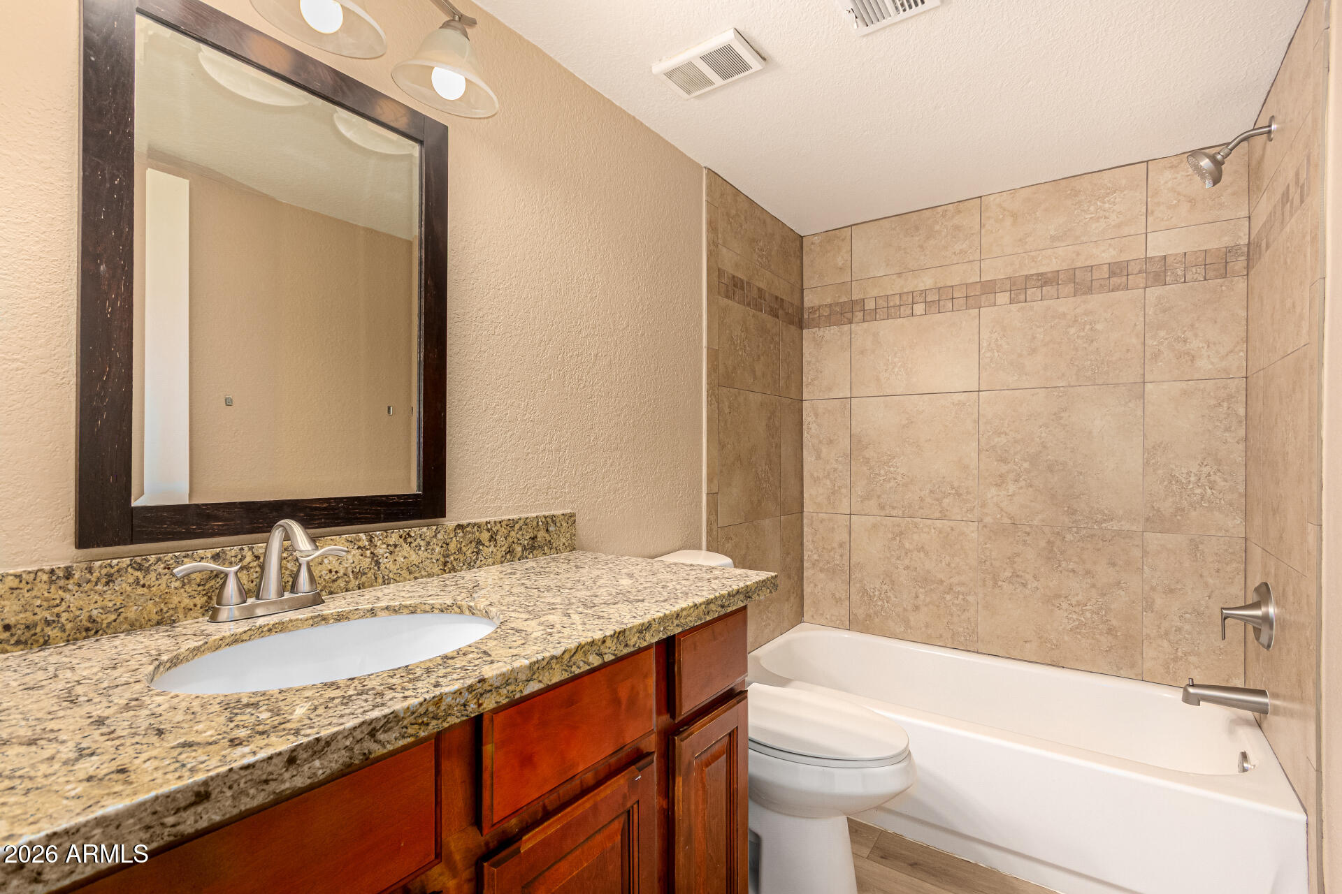 1340 North Recker Road, Unit 343 Mesa, AZ 85205 - Photo 22 of 28 a bathroom with a granite countertop sink toilet and shower