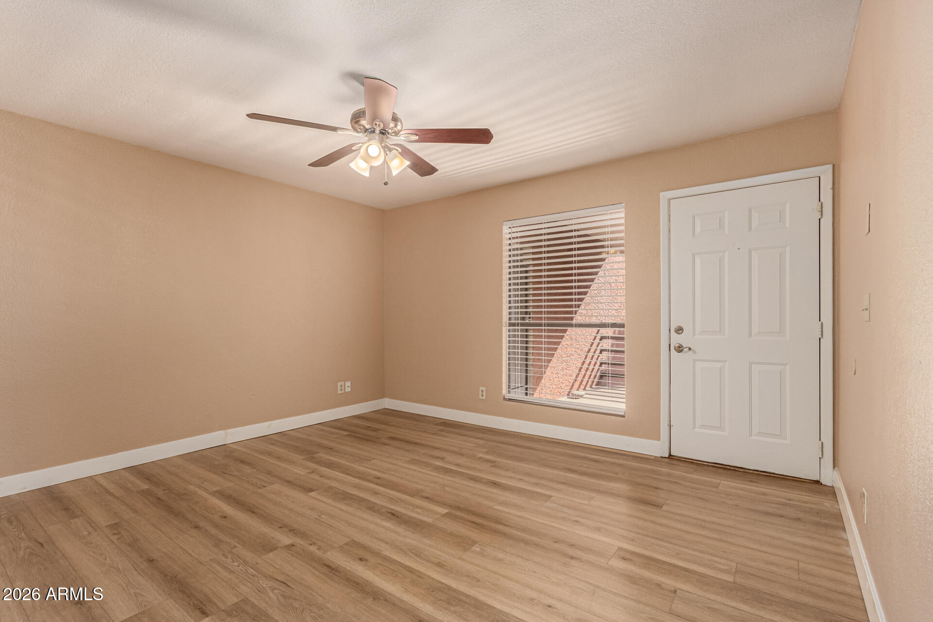 1340 North Recker Road, Unit 343 Mesa, AZ 85205 - Photo 6 of 28 wooden floor in an empty room with a window