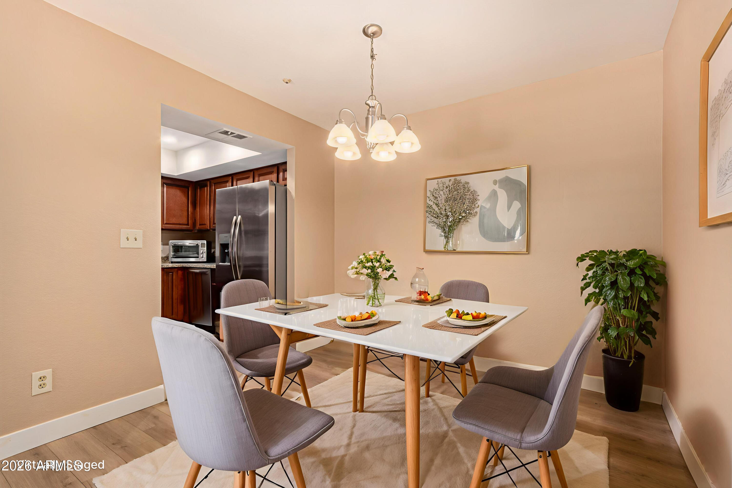 1340 North Recker Road, Unit 343 Mesa, AZ 85205 - Photo 7 of 28 a dining room with furniture potted plants and wooden floor