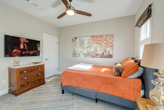 a bedroom with a bed and a large window