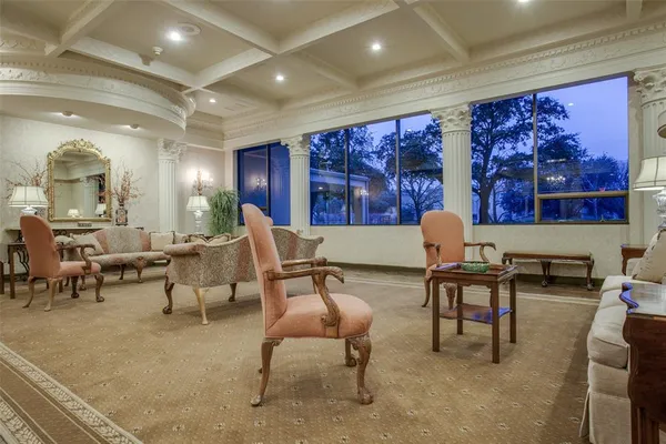 a living room with furniture and painting on the wall