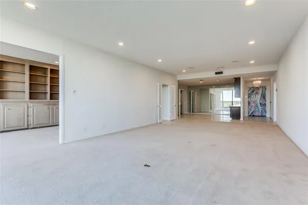 an empty room with furniture and a window