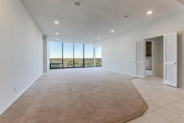 a view of an empty room with closet