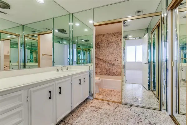 a bathroom with a glass shower door and a bathtub