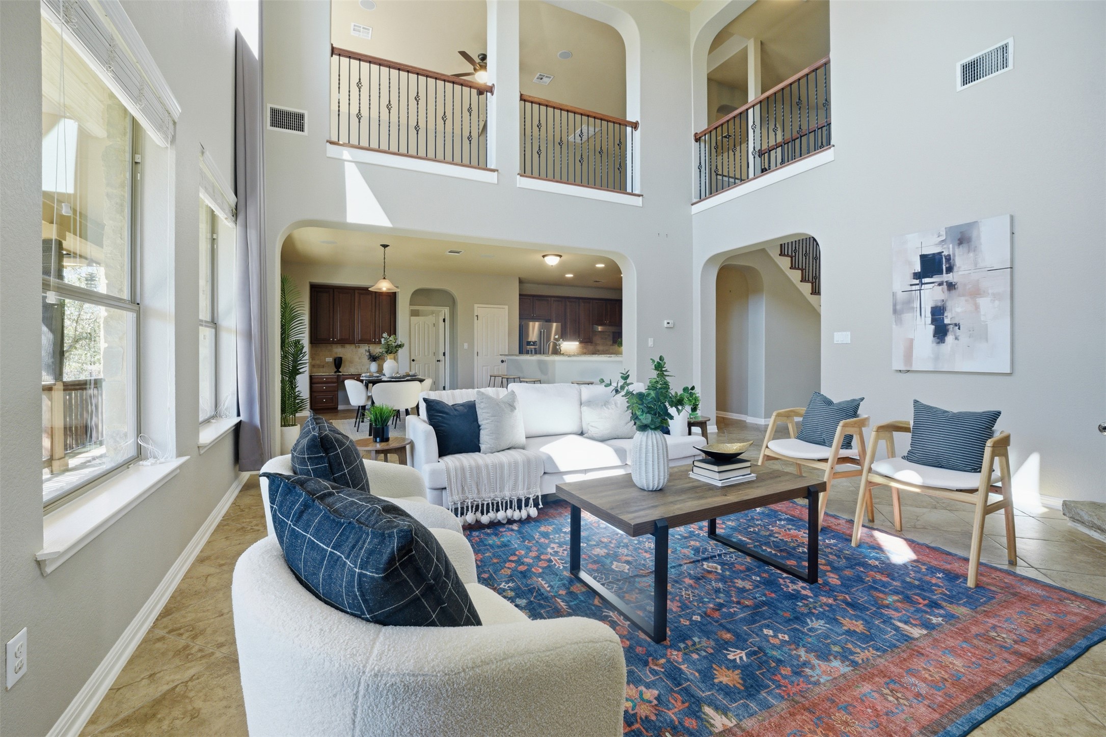16100 Spillman Ranch Loop Austin, TX 78738 - Photo 12 of 39 Living area with arched walkways, a ceiling fan, and a high ceiling