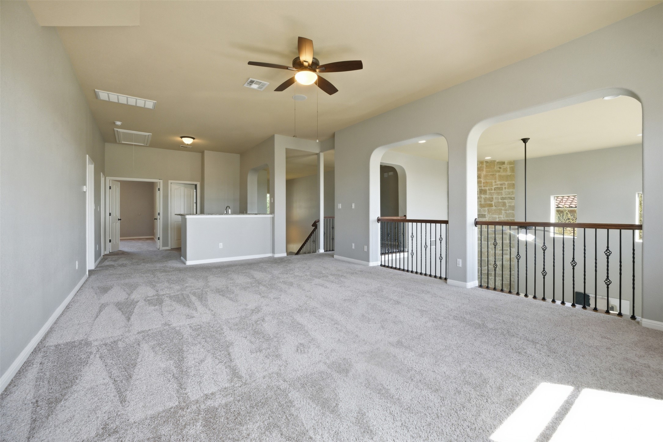 16100 Spillman Ranch Loop Austin, TX 78738 - Photo 28 of 39 Carpeted spare room featuring ceiling fan and arched walkways