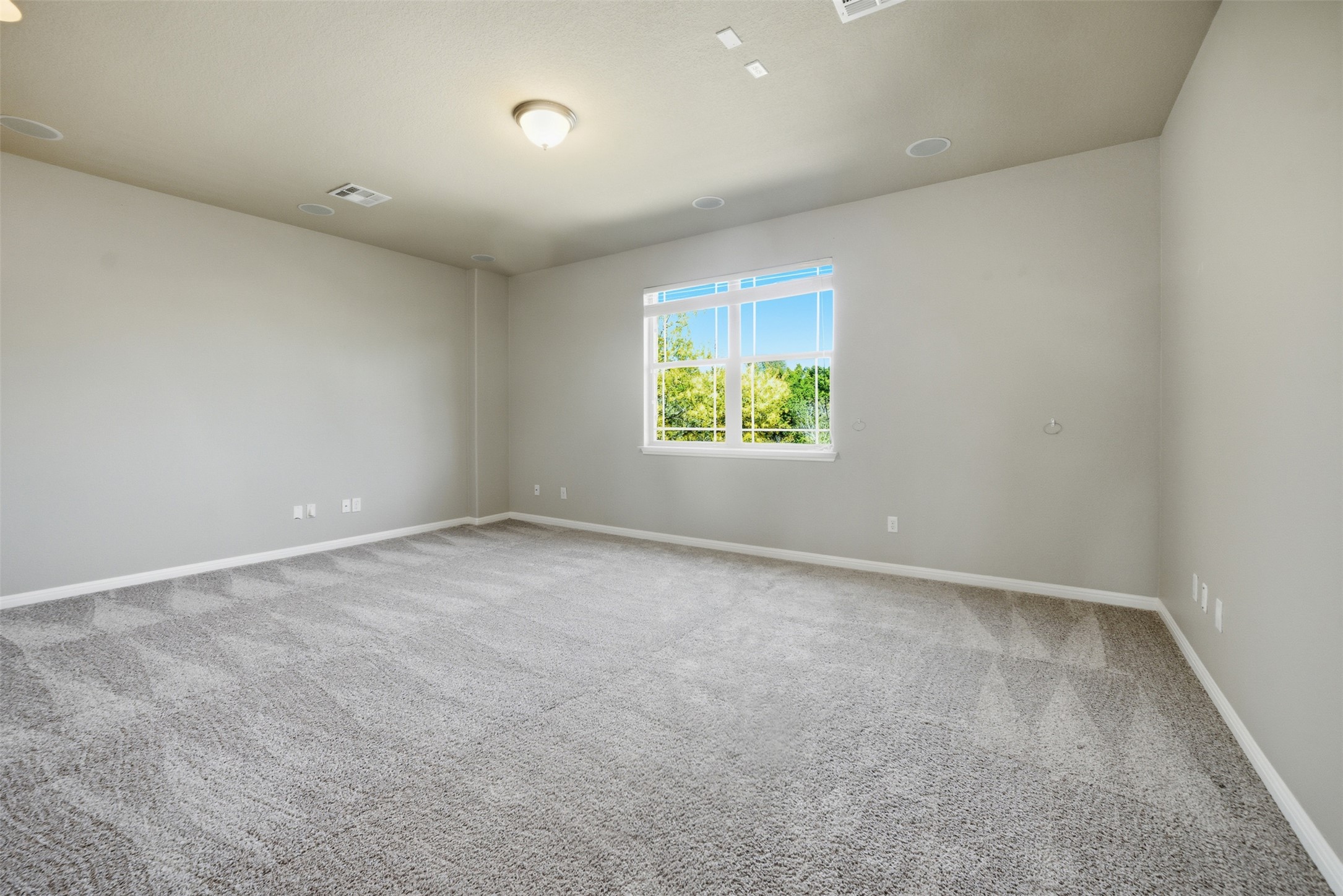 16100 Spillman Ranch Loop Austin, TX 78738 - Photo 34 of 39 Empty room featuring baseboards and light carpet
