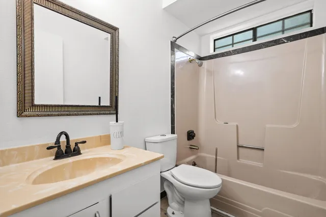 a bathroom with a sink a toilet and a mirror
