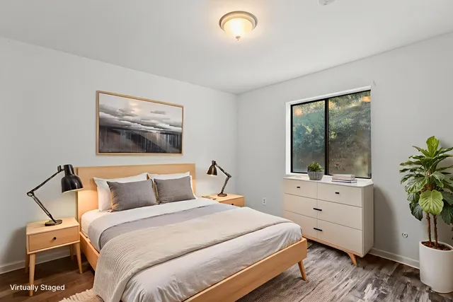 a bedroom with a bed and a potted plant