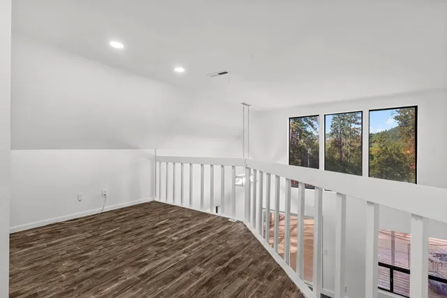 a view of balcony with wooden floor