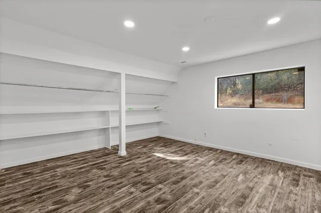 a view of a room with wooden floor and window