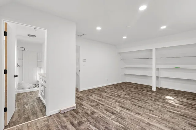 a view of a room with a furniture and wooden floor